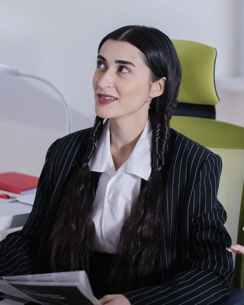 Professional in a pinstripe blazer during a meeting